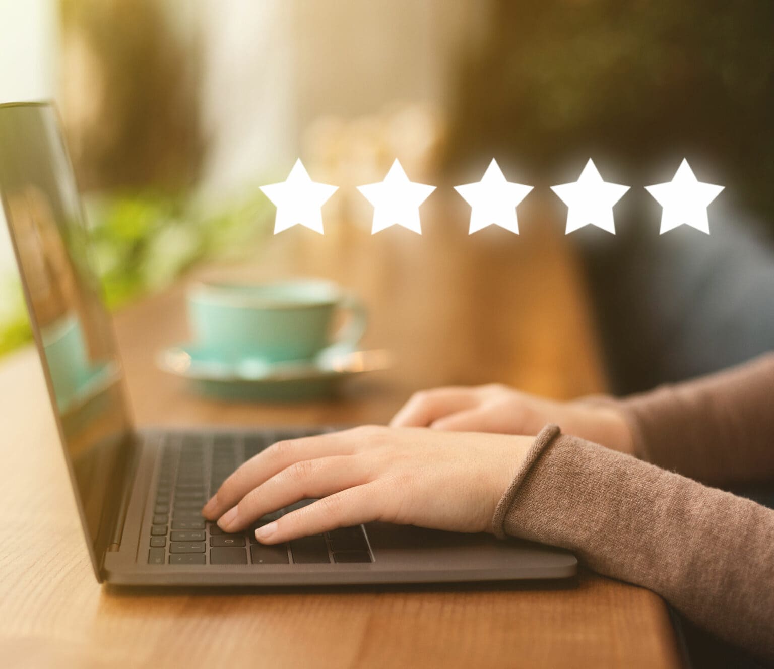 Person on laptop giving a 5-star review to a business
